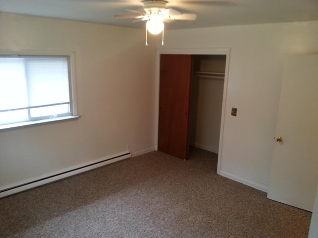 unfurnished bedroom featuring a closet, carpet, a baseboard radiator, and a ceiling fan