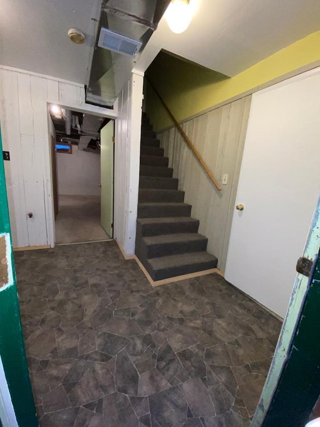 stairs featuring stone finish floor and visible vents