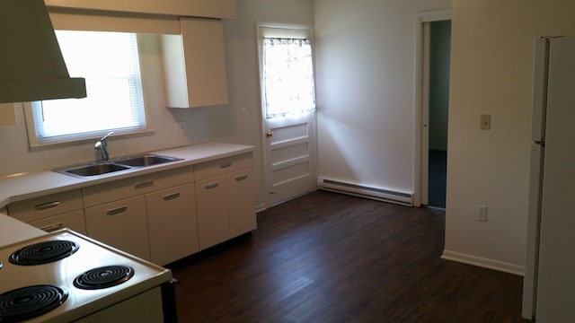 kitchen featuring light countertops, white appliances, a baseboard radiator, and a sink