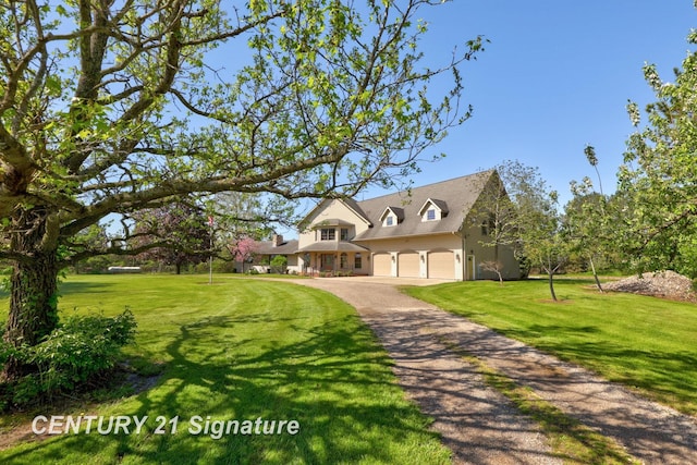 4285 N Iva Rd, Hemlock, MI 48626 - view of front of home with asphalt driveway, a front yard, and an attached garage