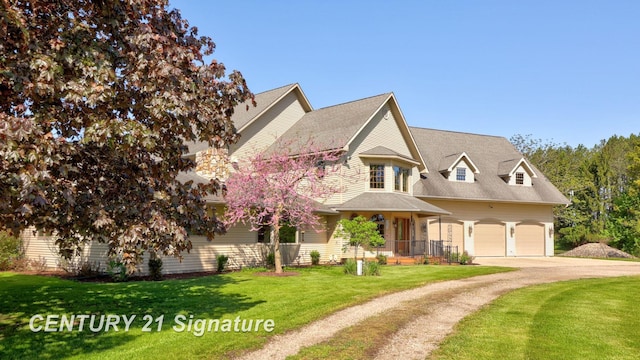 4285 N Iva Rd, Hemlock, MI 48626 - view of front of house with concrete driveway, a front yard, and an attached garage