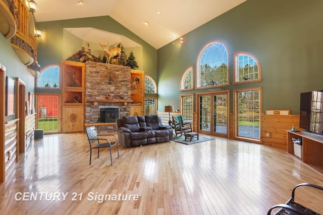 4285 N Iva Rd, Hemlock, MI 48626 - living area featuring high vaulted ceiling, hardwood / wood-style floors, and a stone fireplace