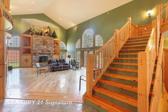 4285 N Iva Rd, Hemlock, MI 48626 - stairway with high vaulted ceiling, plenty of natural light, and a fireplace
