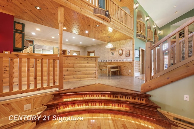 4285 N Iva Rd, Hemlock, MI 48626 - stairway featuring wallpapered walls, a high ceiling, recessed lighting, and baseboards
