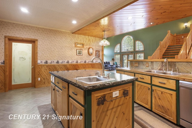 4285 N Iva Rd, Hemlock, MI 48626 - kitchen featuring a sink, stainless steel dishwasher, wainscoting, a kitchen island with sink, and wooden walls