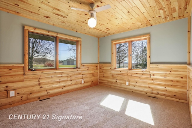 4285 N Iva Rd, Hemlock, MI 48626 - unfurnished room featuring rustic walls, carpet floors, wood ceiling, and a ceiling fan
