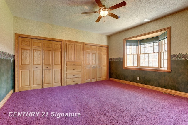 4285 N Iva Rd, Hemlock, MI 48626 - unfurnished bedroom featuring multiple closets, a textured ceiling, carpet floors, and ceiling fan