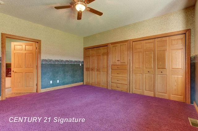 4285 N Iva Rd, Hemlock, MI 48626 - unfurnished bedroom with multiple closets, a textured ceiling, carpet floors, wallpapered walls, and a ceiling fan