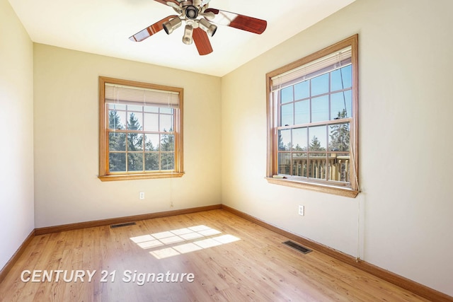 4285 N Iva Rd, Hemlock, MI 48626 - unfurnished room with healthy amount of natural light, baseboards, wood finished floors, and ceiling fan