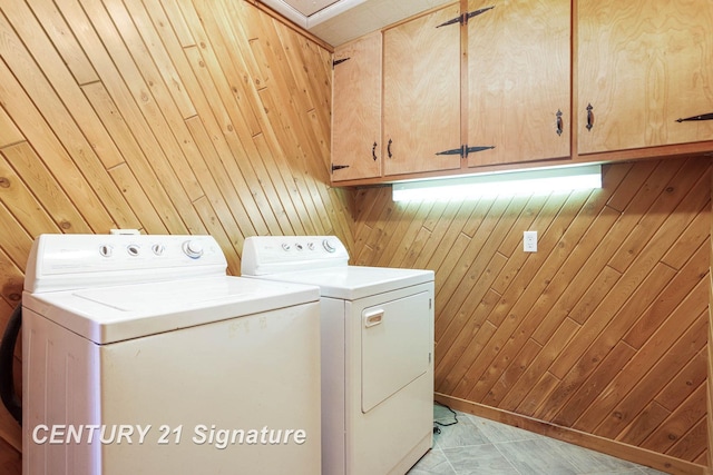 4285 N Iva Rd, Hemlock, MI 48626 - laundry area with cabinet space, washing machine and dryer, and wood walls