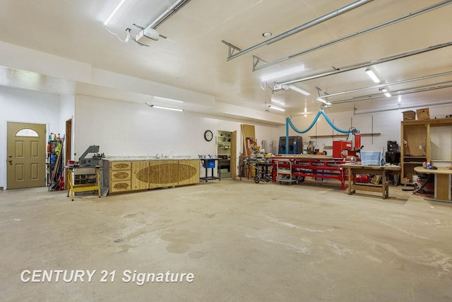 4285 N Iva Rd, Hemlock, MI 48626 - garage with a workshop area and a garage door opener