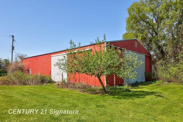 4285 N Iva Rd, Hemlock, MI 48626 - view of side of property featuring a pole building, a lawn, and an outbuilding