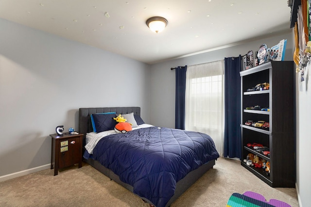 carpeted bedroom with baseboards