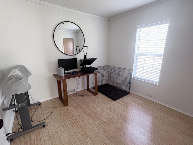 home office featuring ornamental molding, baseboards, wood finished floors, and a healthy amount of sunlight