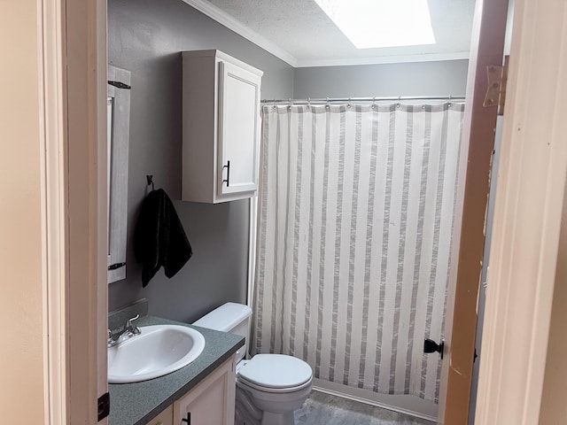 bathroom with vanity, ornamental molding, a shower with curtain, toilet, and a skylight