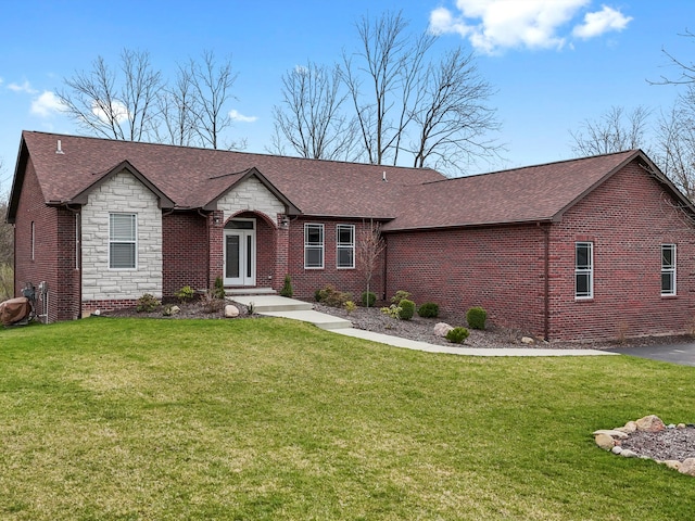 ranch-style house with brick siding, stone siding, and a front yard
