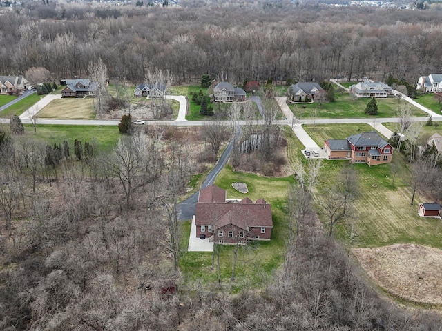 aerial view featuring a residential view and a wooded view
