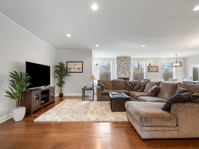 living area featuring baseboards, an inviting chandelier, and recessed lighting