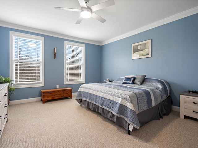 carpeted bedroom featuring ceiling fan, baseboards, and ornamental molding