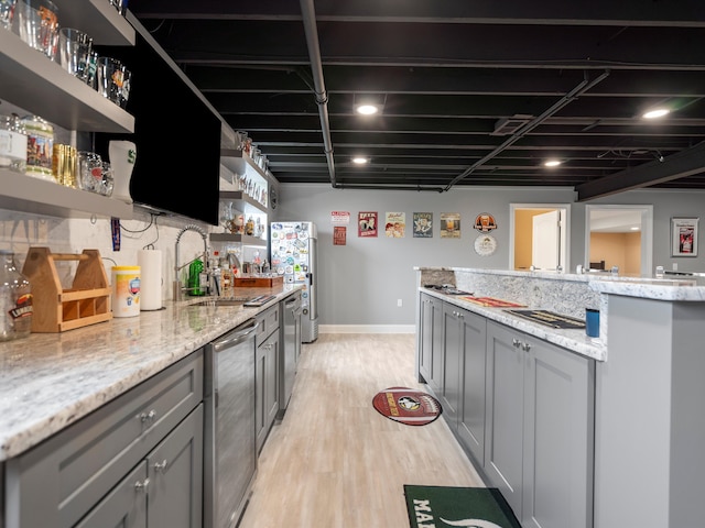 kitchen featuring light wood finished floors, beverage cooler, gray cabinets, open shelves, and light stone countertops