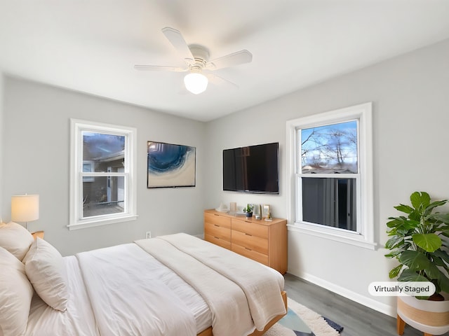 bedroom featuring wood finished floors, ceiling fan, and baseboards