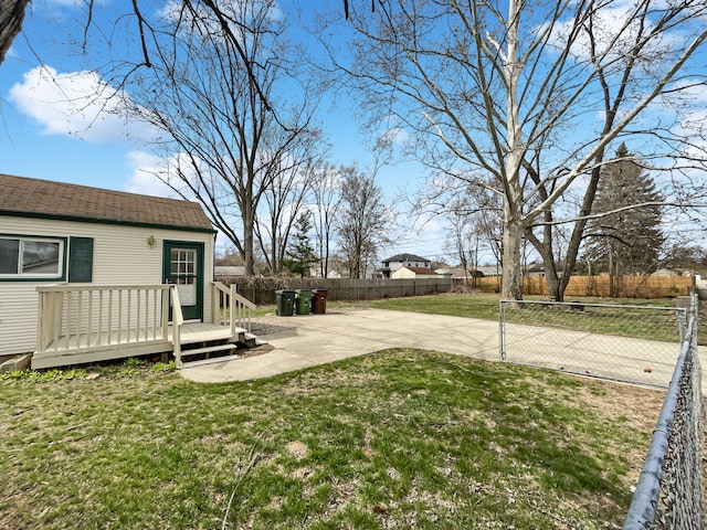 view of yard with a patio area, a fenced backyard, and a wooden deck
