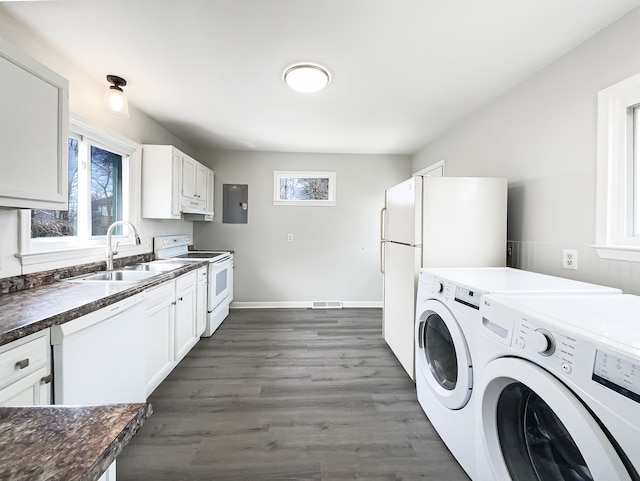 clothes washing area featuring dark wood-style flooring, baseboards, washer and clothes dryer, laundry area, and a sink