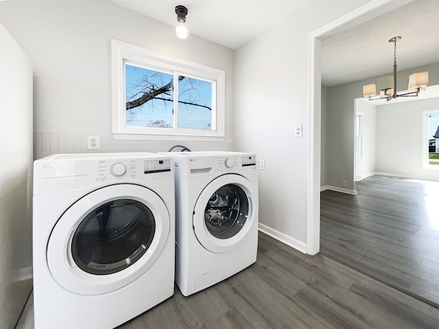 laundry room featuring independent washer and dryer, a chandelier, dark wood finished floors, and a healthy amount of sunlight