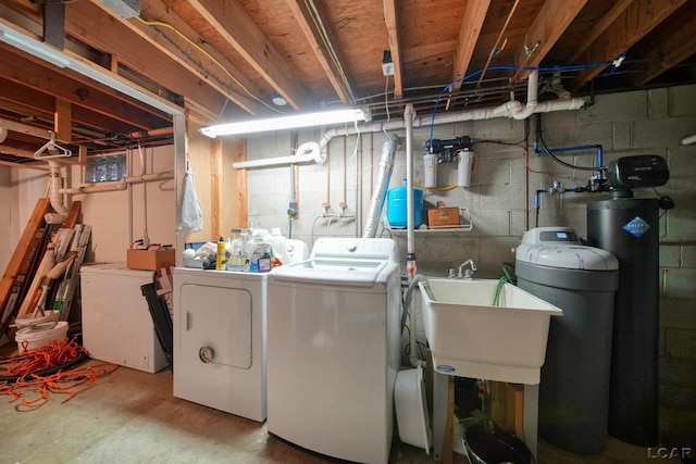 clothes washing area with a sink, washing machine and clothes dryer, and laundry area