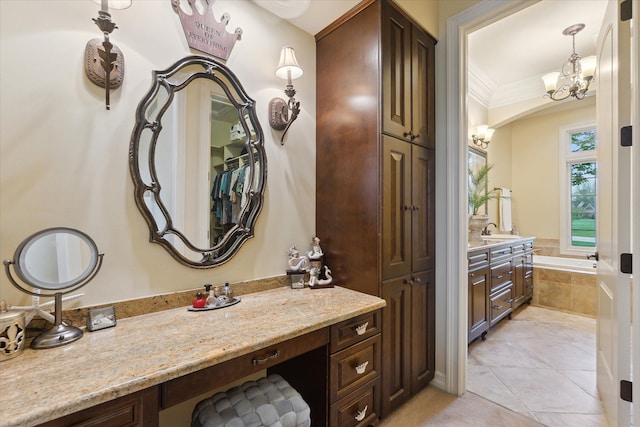full bathroom featuring vanity, a chandelier, tile patterned flooring, a bath, and ornamental molding