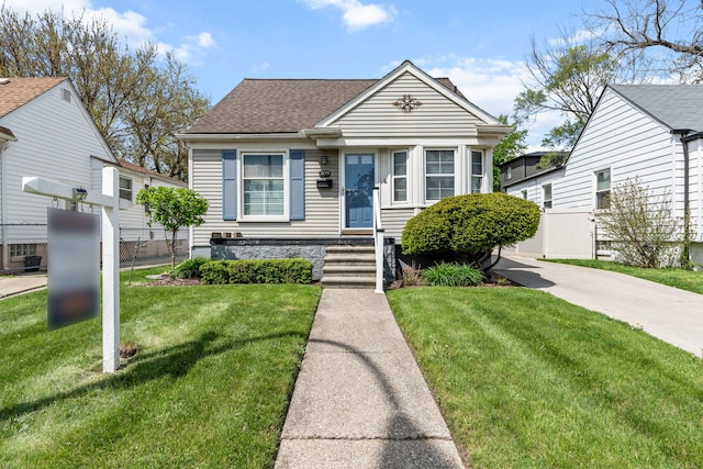 bungalow-style home with a shingled roof