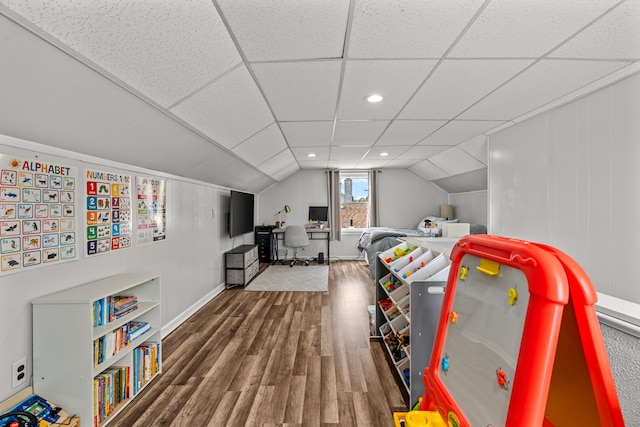 bedroom with wood finished floors and lofted ceiling