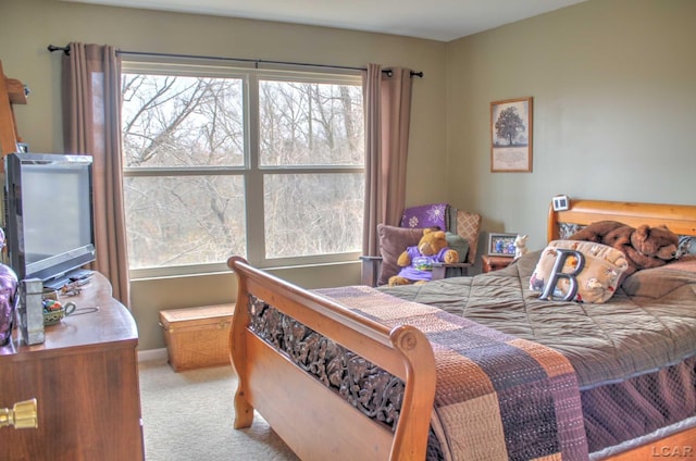 bedroom with carpet and baseboards
