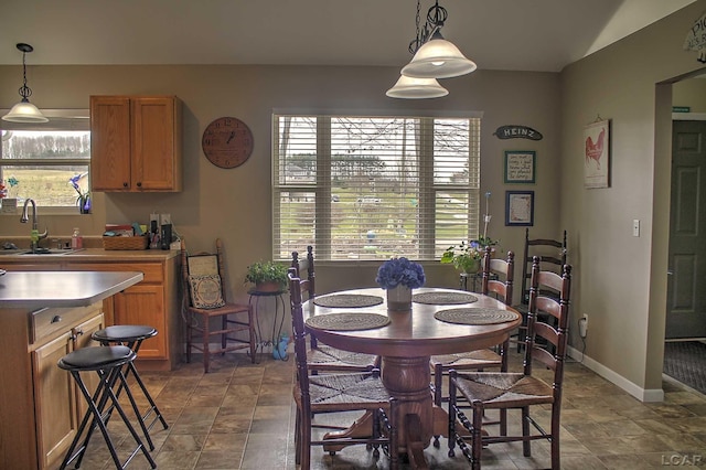 dining space with stone finish flooring and baseboards
