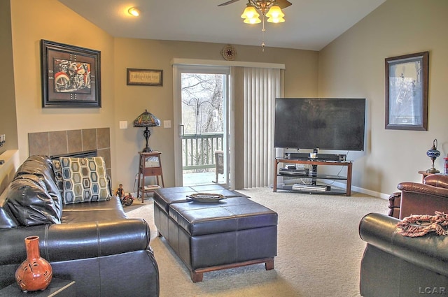 living area featuring a fireplace, baseboards, carpet floors, and ceiling fan