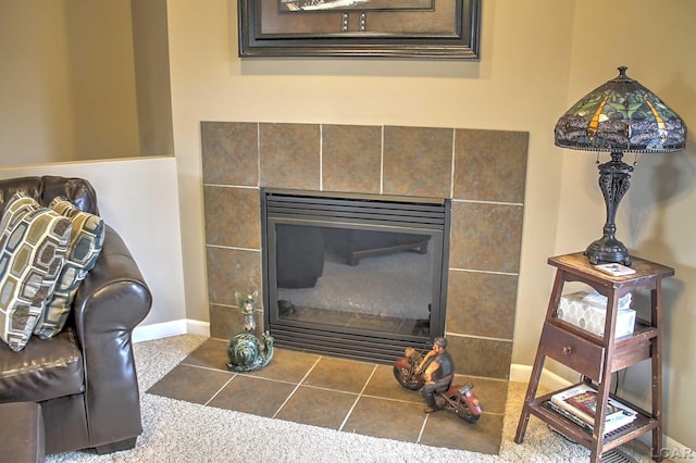 room details featuring baseboards and a fireplace