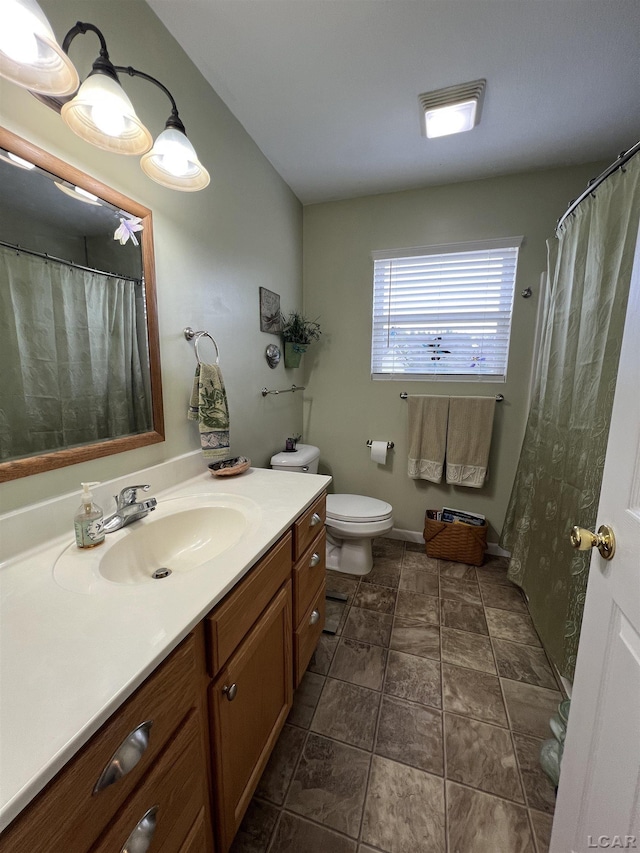 bathroom with toilet and vanity