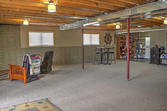 below grade area featuring carpet and a healthy amount of sunlight