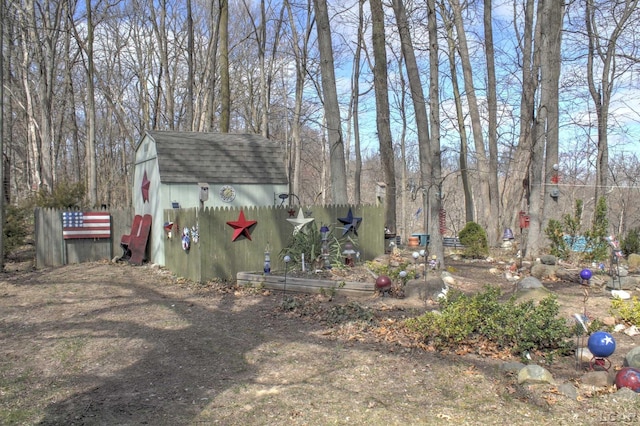 view of yard featuring a storage unit and an outbuilding