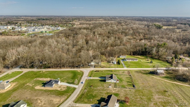 birds eye view of property featuring a view of trees