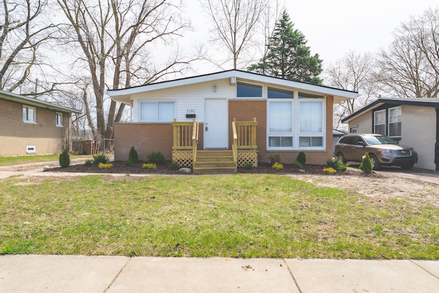 1182 Dudley Ave, Pontiac, MI 48342 - view of front facade featuring brick siding and a front lawn