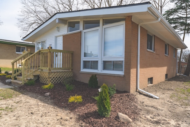 1182 Dudley Ave, Pontiac, MI 48342 - view of side of home featuring brick siding and a wooden deck
