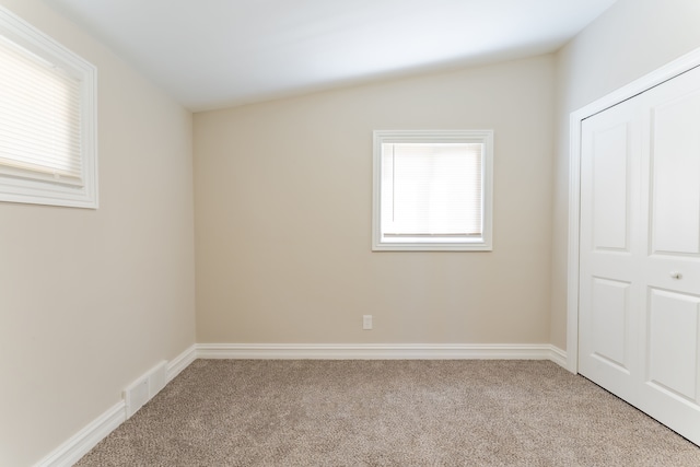 1182 Dudley Ave, Pontiac, MI 48342 - unfurnished bedroom featuring light carpet, visible vents, and baseboards