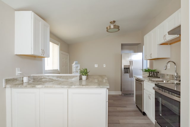 1182 Dudley Ave, Pontiac, MI 48342 - kitchen with a peninsula, white cabinetry, a sink, and appliances with stainless steel finishes