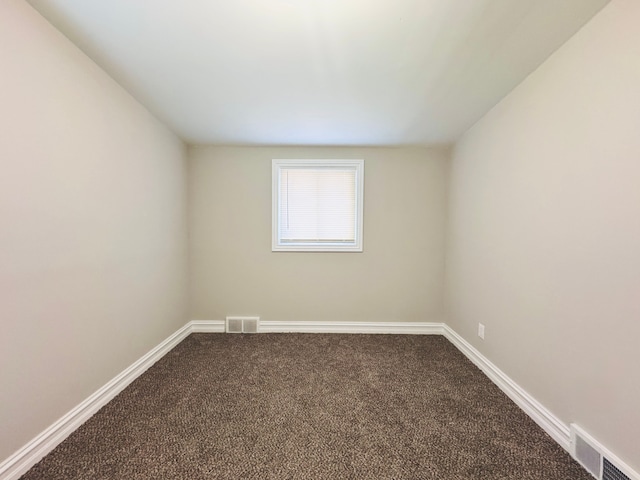 1182 Dudley Ave, Pontiac, MI 48342 - spare room featuring dark carpet, baseboards, and visible vents