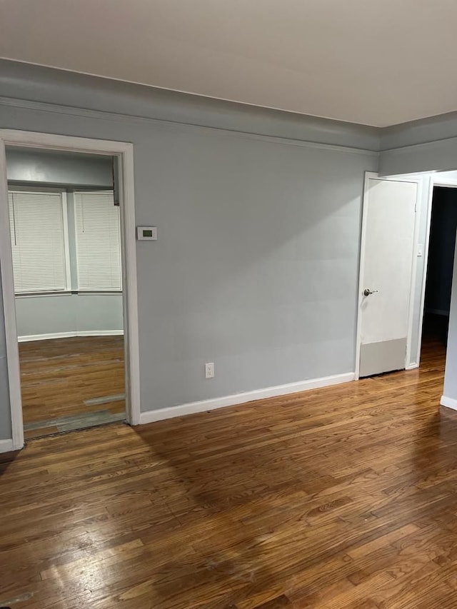 empty room with wood finished floors and baseboards