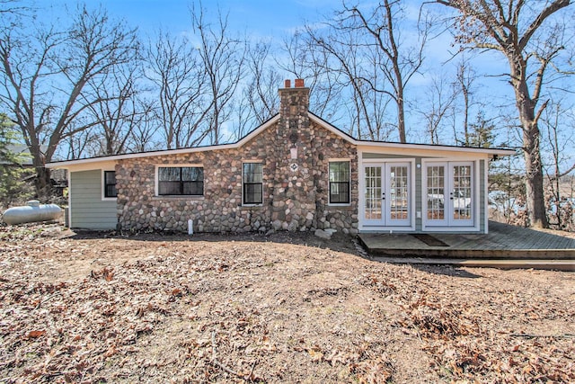 201 Templar Ave, Pinckney, MI 48169 - view of front of property featuring stone siding, french doors, a chimney, and a deck