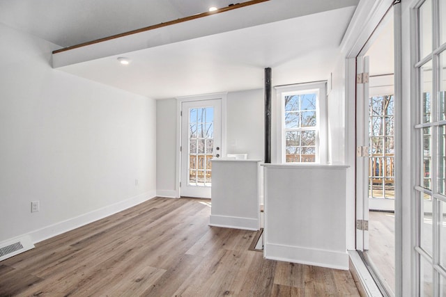 201 Templar Ave, Pinckney, MI 48169 - empty room with baseboards, visible vents, and wood finished floors