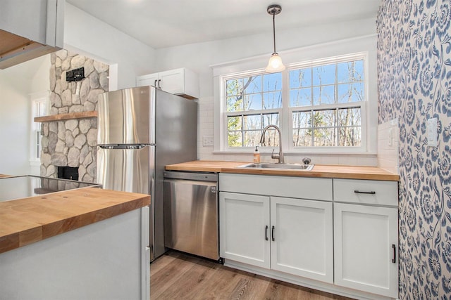 201 Templar Ave, Pinckney, MI 48169 - kitchen with a sink, stainless steel appliances, light wood-type flooring, and butcher block counters