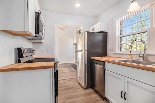201 Templar Ave, Pinckney, MI 48169 - kitchen featuring a sink, stainless steel appliances, light wood-type flooring, and butcher block counters